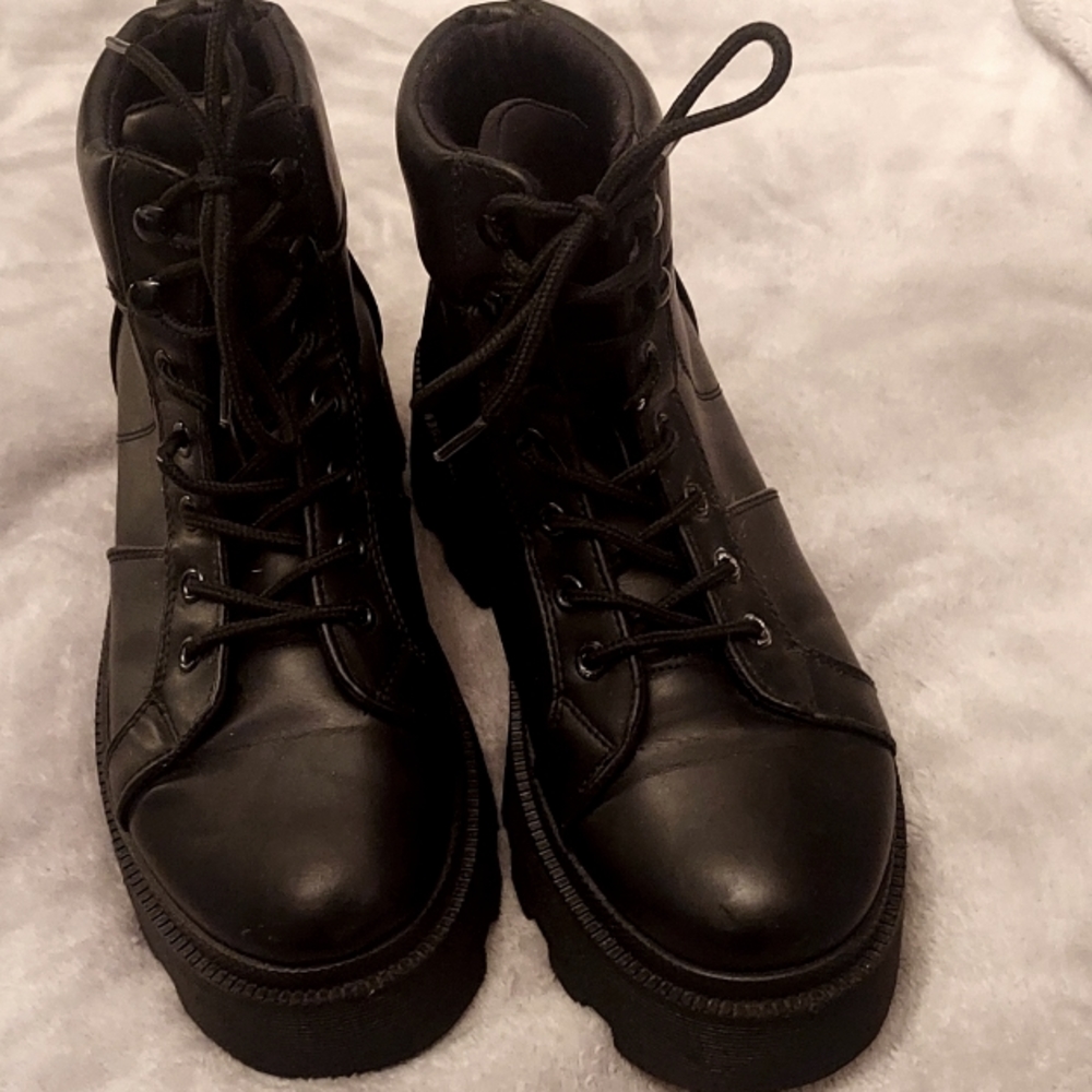 Black Lug sole lace-up boots .